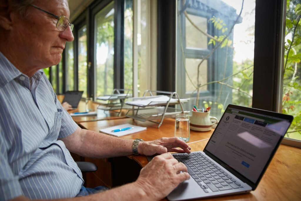 Senior man using laptop at home